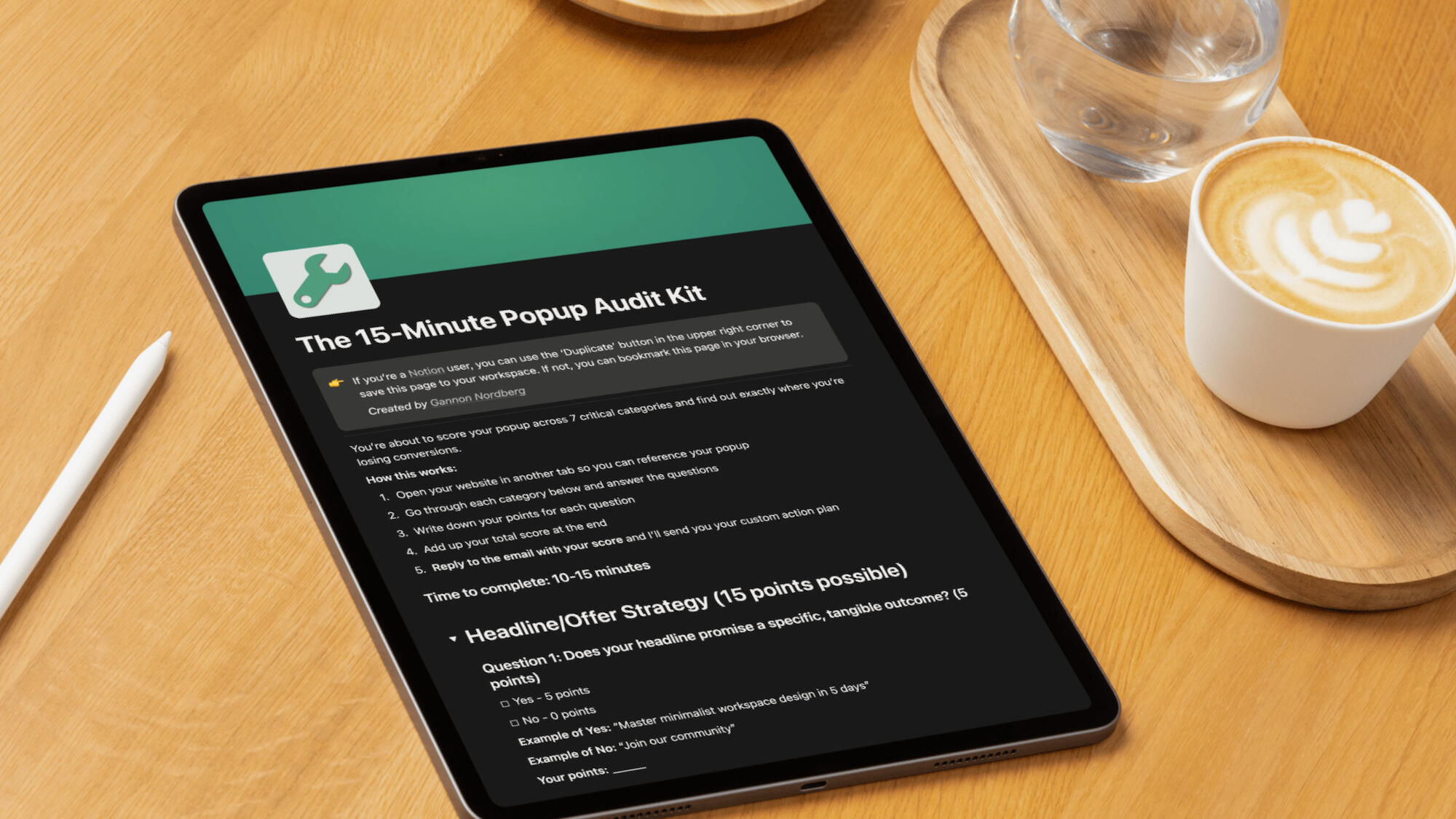 iPad mockup on a light wood table with an espresso and stylus